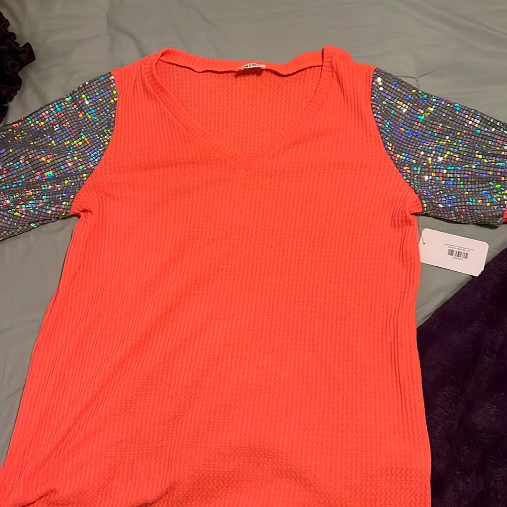 New with tangs . Orange shirt with glittery sleeves
